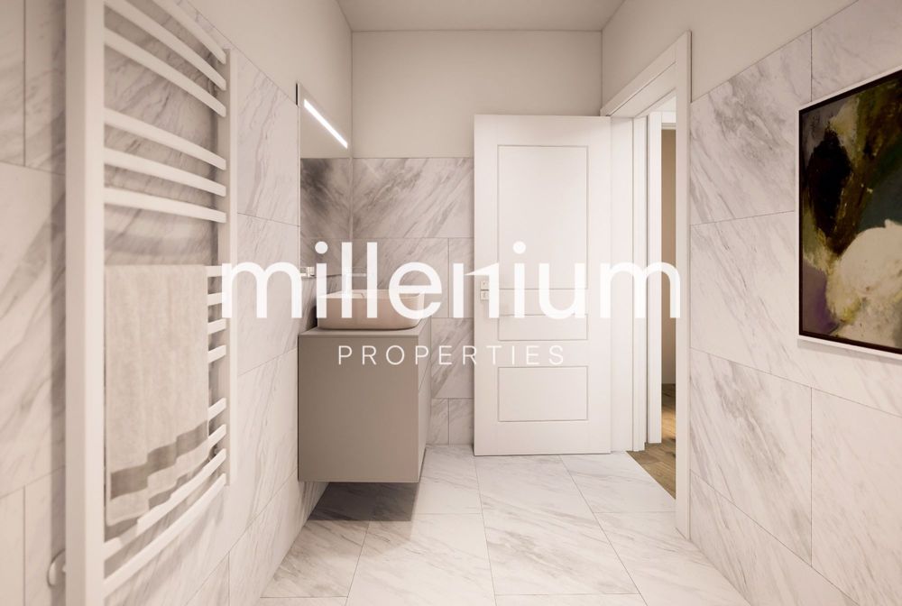 Projet STIERLIN - Villa F - une salle de bains moderne avec un lavabo blanc et un tableau au mur / a modern bathroom with a white sink and a painting on the wall