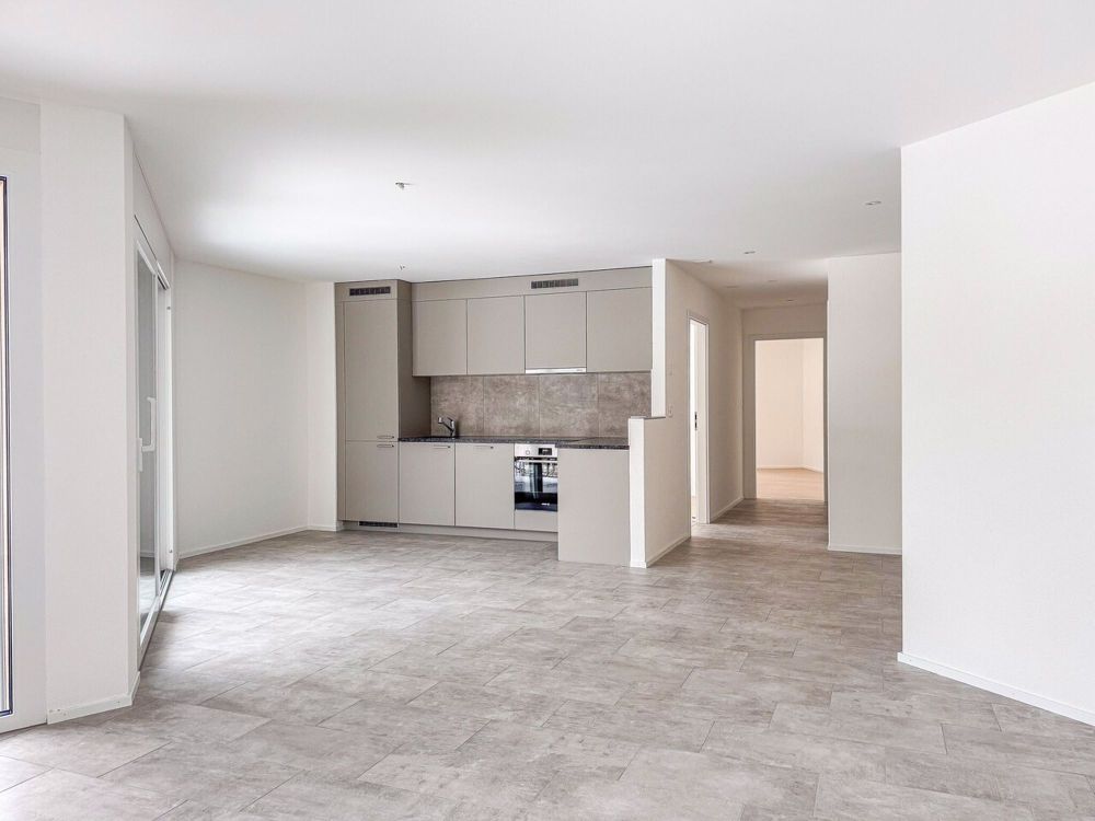 Neue 3.5-Zimmer-Wohnung, Terrasse und Garten in Campagne Pernod, Lot B3 - Exemple d'agencement intérieur cuisine et séjour (bâtiment A - 3.5 pièces)