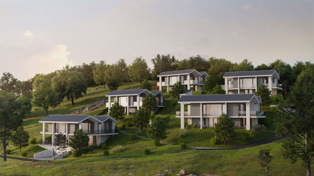 Villa E mit Traum-Aussicht über den Murtensee - / modern houses on a green hillside with trees