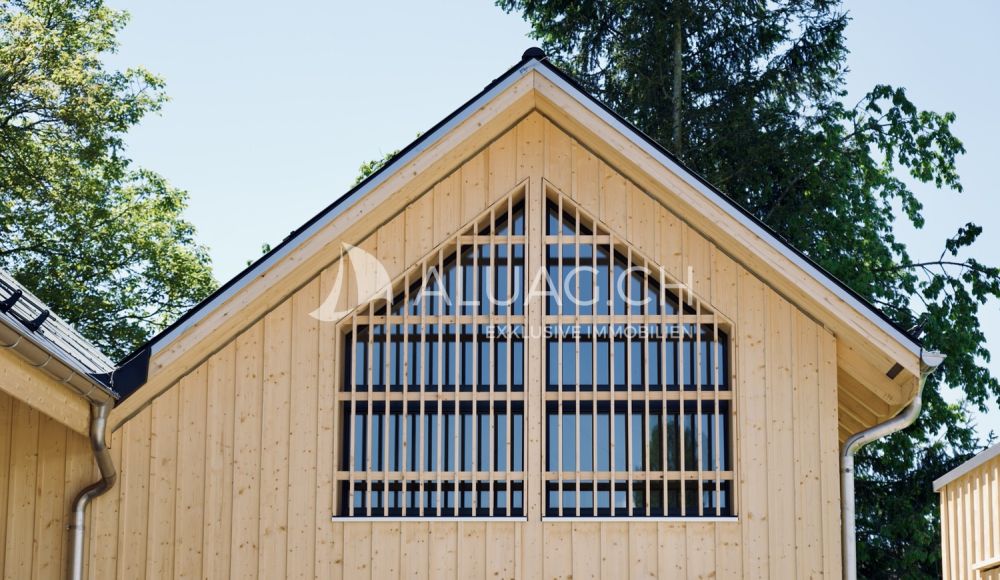 NEUBAU - 3.5 ZIMMER DUPLEX WOHNUNG - Die markante Holzfassade mit grosser Fensterfront fügt sich modern in das Ortsbild ein