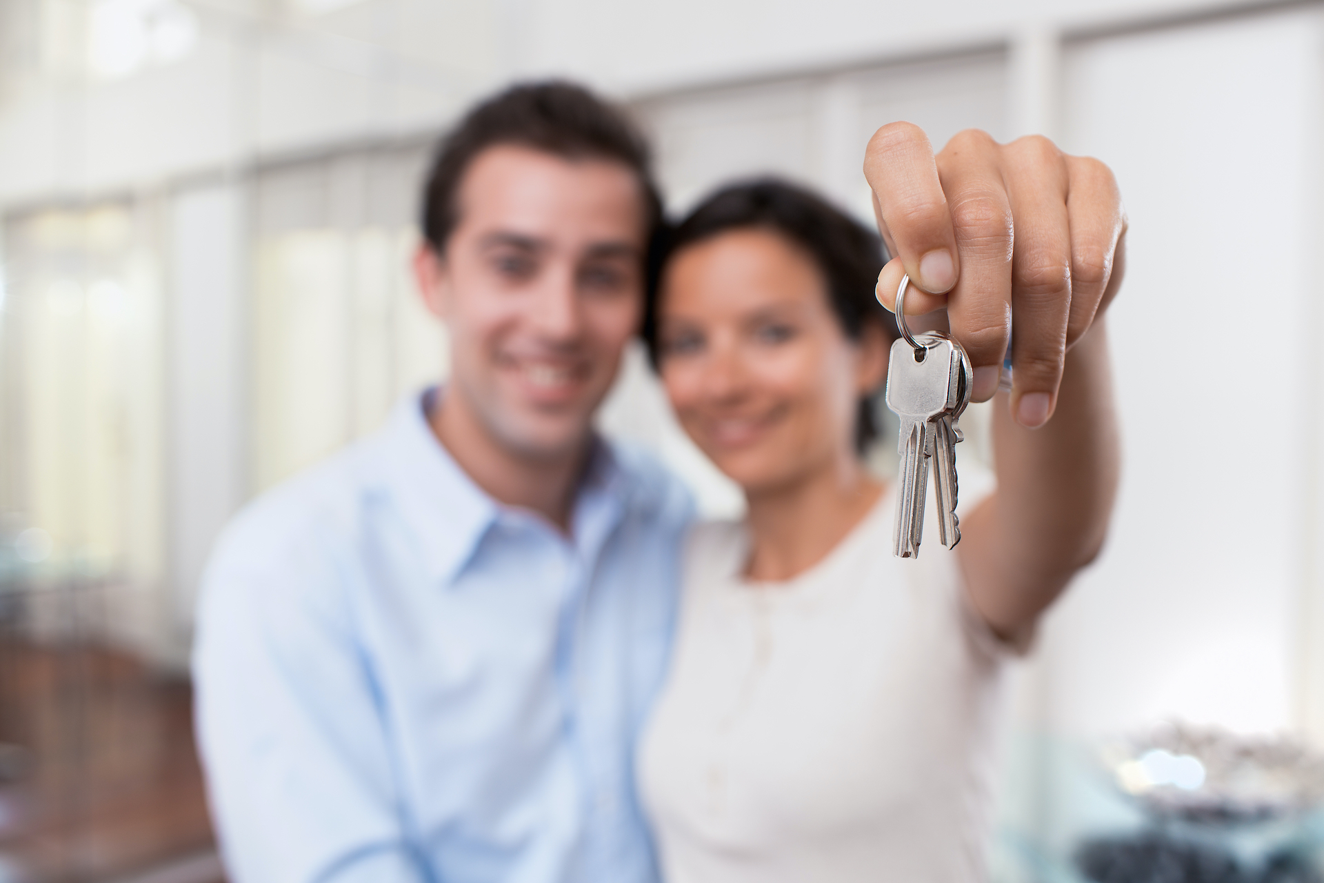 Happy,Smiling,Young,Couple,Showing,A,Keys,Of,Their,New