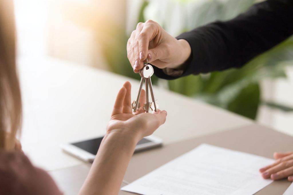 Young,Lady,Taking,Keys,From,Female,Real,Estate,Agent,During